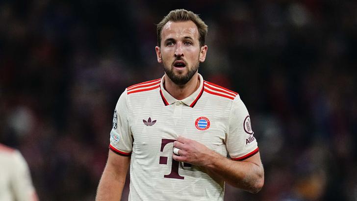 Harry Kane in a white Bayern Munich jersey watches on during a game in the Bundesliga